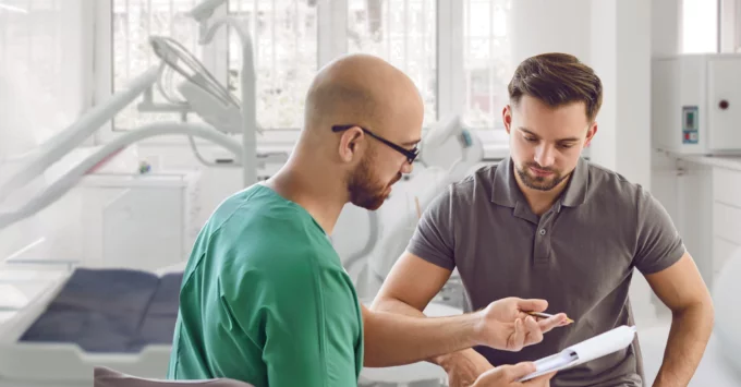 Clinician speaking with young male patient